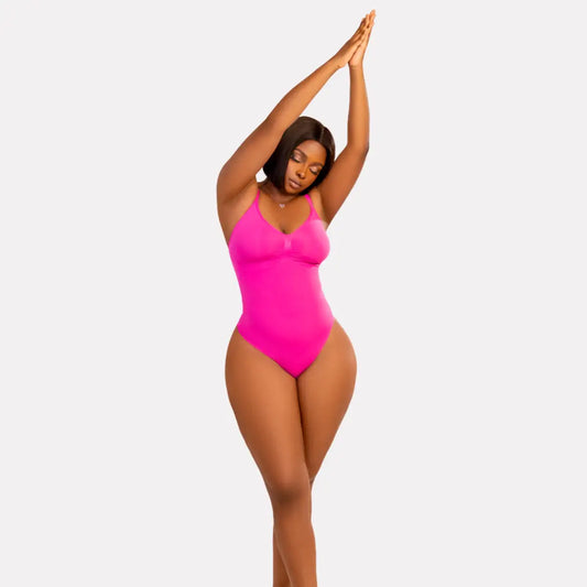 Model showcasing Getfit Glove Thong in vibrant pink, demonstrating comfort and seamless shaping for all occasions.